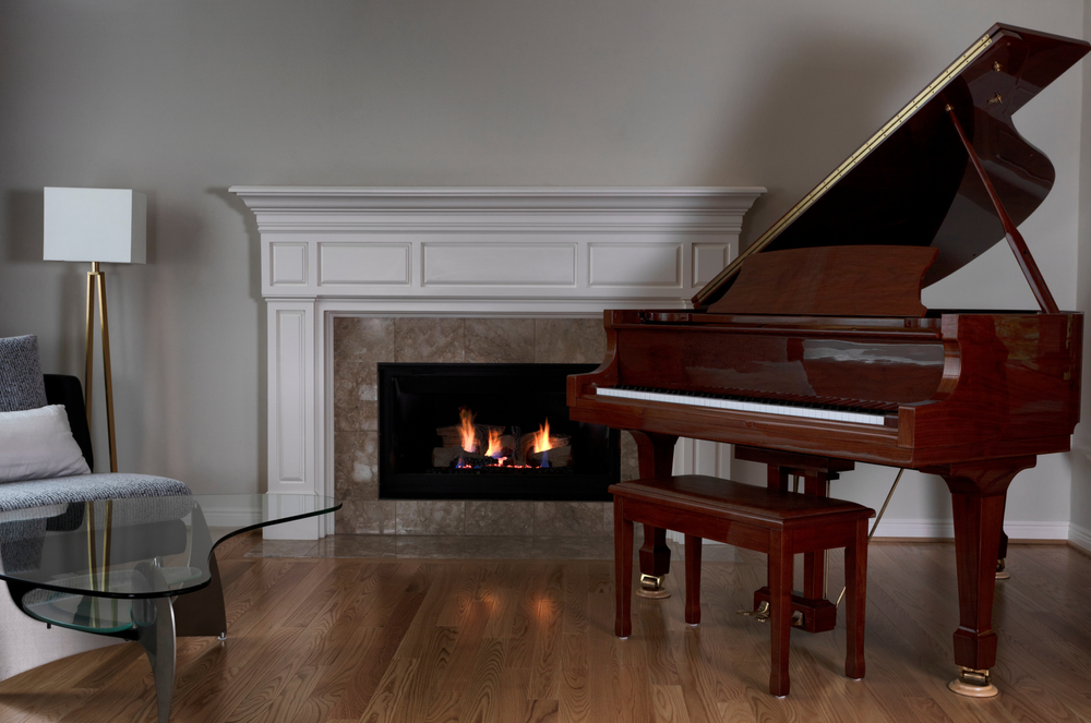Glowing,Fireplace,With,Baby,Grand,Piano,On,Solid,Red,Oak