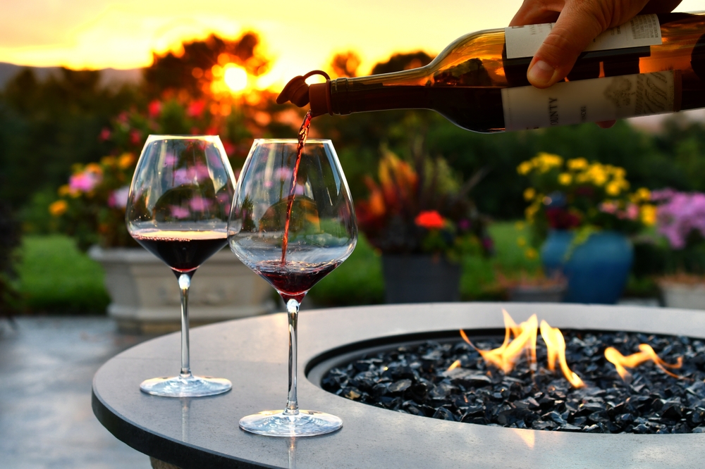 Pouring,Red,Wine,Into,Glasses,At,Sunset,Golden,Hour,Next